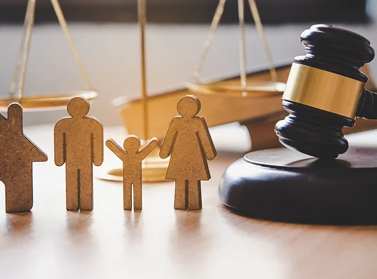 a group of wooden figures next to a gavel