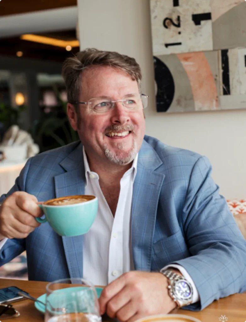 a man in a suit holding a cup of coffee